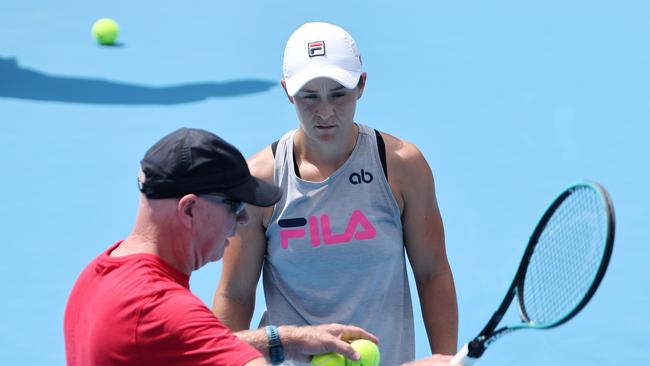 Ash Barty talks with coach Craig Tyzzer during a training session.