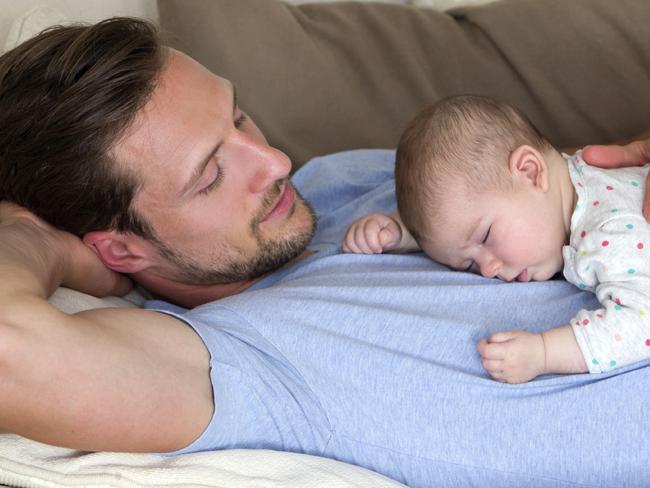 istock. Dad and sleeping baby