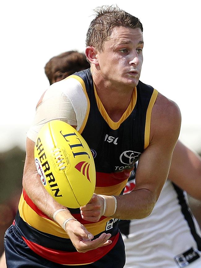 Crows Matt Crouch unloads the handball. Picture Sarah Reed