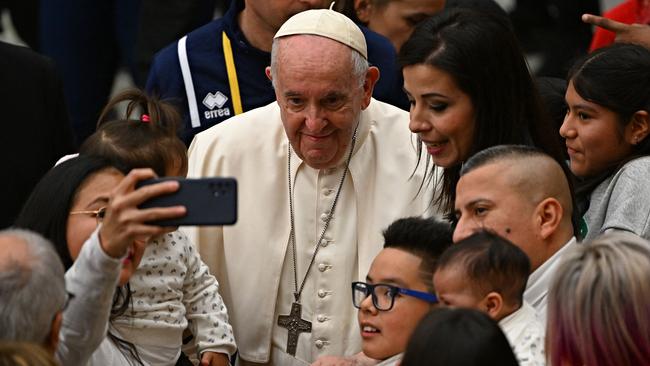 Pope Francis greets children and staff of the Santa Marta Dispensary during a private audience. Picture: AFP.