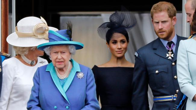 Queen Elizabeth II, Meghan, Duchess of Sussex, Prince Harry, Duke of Sussex, watch the military fly-past to mark the centenary of the Royal Air Force (RAF).