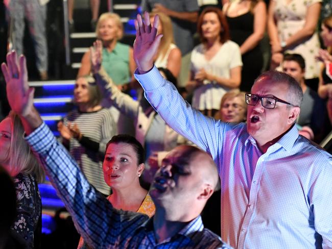 *This picture has been selected as one of the Best of the Year News images for 2019* Prime Minister Scott Morrison and wife Jenny sing during an Easter Sunday service at his Horizon Church at Sutherland in Sydney, Sunday, April 21, 2019. (AAP Image/Mick Tsikas) NO ARCHIVING