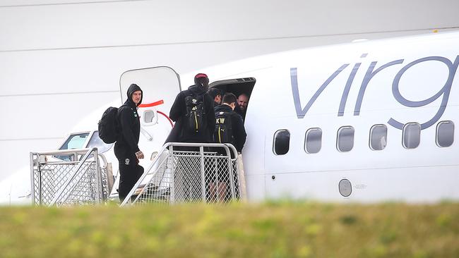 AFL footballers from the Western Bulldogs and Richmond board a Vigin airlines flight to Queensland as part of an AFL hub due to the coronavirus lockdowns in Melbourne. Picture: Ian Currie