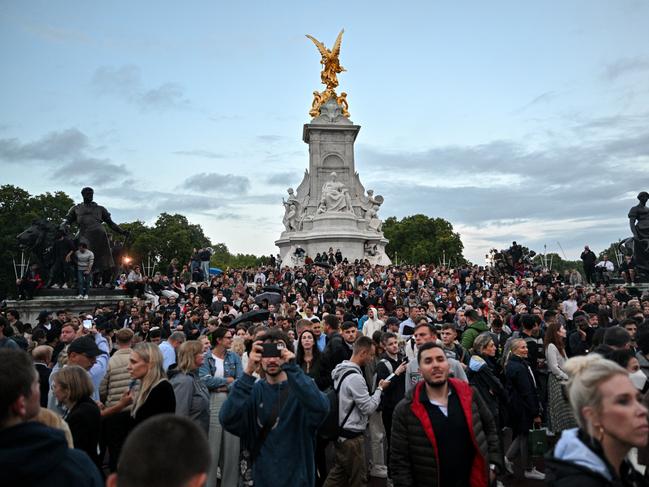 Members of the public gather on The Victoria Memorial also known as the Wedding Cake outside Buckingham Palace. Picture: Wire image.