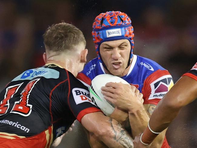 NEWCASTLE, AUSTRALIA - MARCH 13: KalynÃÂ Ponga of the Knights is tackled during the round two NRL match between Newcastle Knights and Dolphins at McDonald Jones Stadium, on March 13, 2025, in Newcastle, Australia. (Photo by Scott Gardiner/Getty Images)