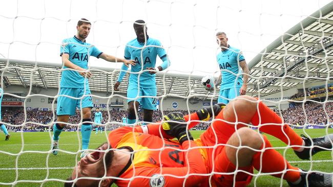 Spurs players rush to aid a stricken Hugo Lloris.