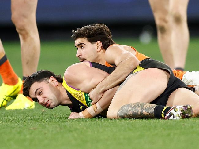 MELBOURNE, AUSTRALIA – JULY 14: Tim Taranto of the Tigers is tackled by Toby Bedford of the Giants during the 2024 AFL Round 18 match between the Richmond Tigers and the GWS GIANTS at Melbourne Cricket Ground on July 14, 2024 in Melbourne, Australia. (Photo by Michael Willson/AFL Photos via Getty Images)