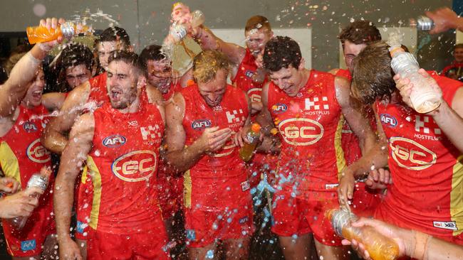 Gold Coast players make the most singing the club song after a rare win. Picture: Getty Images