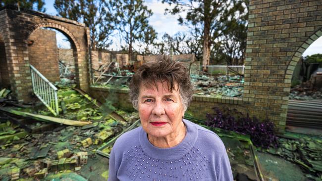 Pam Johnson at the ruins of her Catalina home which burned down on New Year’s morning. Picture: Josh Burkinshaw,