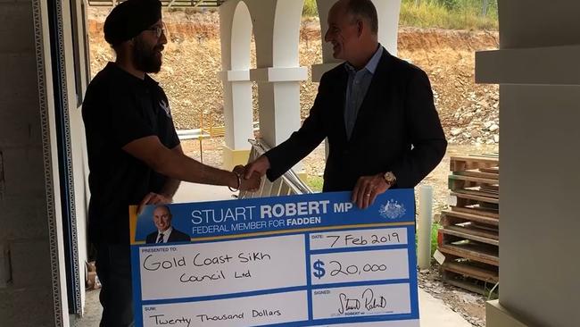 Fadden MP Stuart Robert presented Mr Singh with a $20,000 grant.