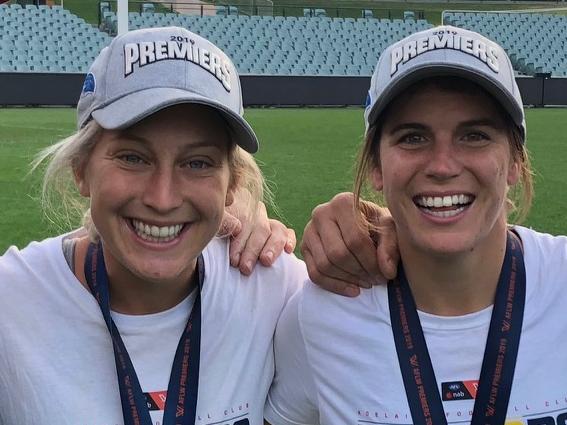 Boyzone's Brian McFadden and Mark Soderstrom with Crows AFLW premiership stars Marijana Rajcic and Chelsea Randall re-enact the big moments from the grand final on Adelaide Oval. Pic: Mark Soderstrom - all good to use.