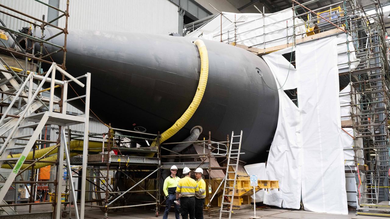 Workers stand by a submarine at the Osborne shipyard in Adelaide. Mr Dutton said he would invest in Australian defence industry. Picture: NewsWire / Morgan Sette