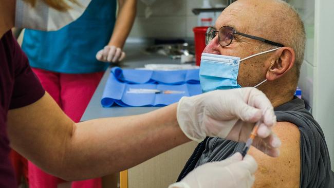 A health worker gives a Pfizer/BioNTech COVID-19 jab to an elderly man in Krakow, Poland, this week. Picture: Getty Images