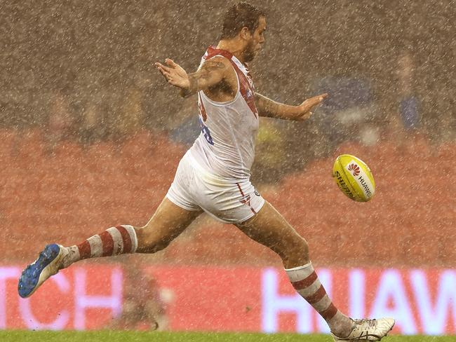 Lance Franklin kicks through the torrential rain. Picture: AAP