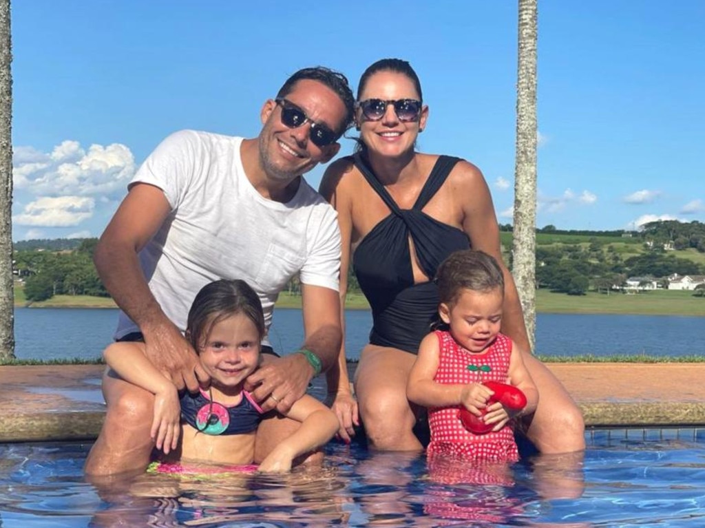 Personal trainer Luciana Lourencao pictured with her husband and two daughters.