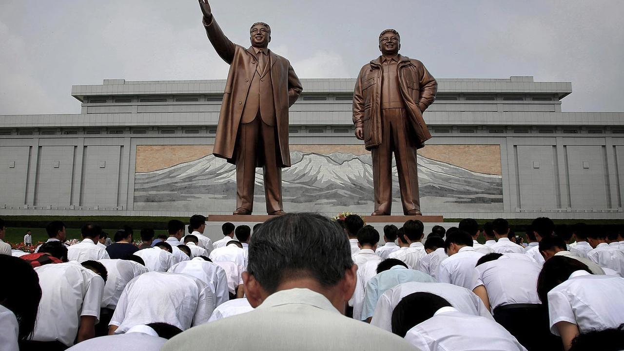 North Koreans bow in front of bronze statues of the late leaders Kim Il-sung, left, and Kim Jong-il. Pic: AP