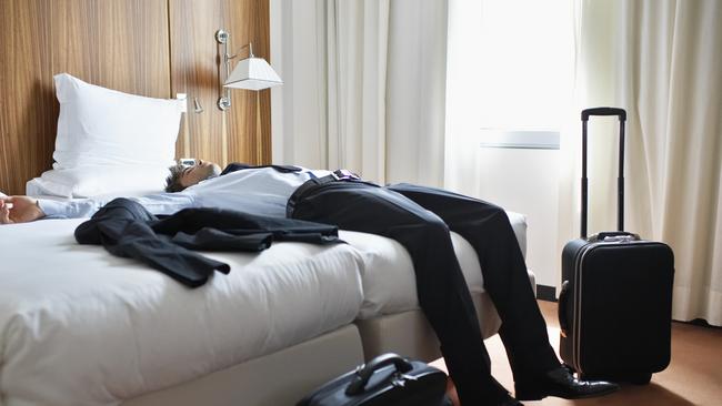 Businessman Sleeping in Motel Room