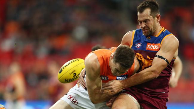 Jeremy Cameron of the Giants crashes in to Lions veteran Luke Hodge. Picture: Getty Images