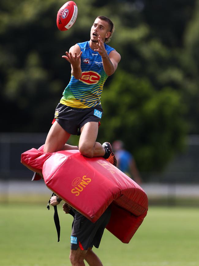 Former star Wanderers forward Joel Jeffrey marks during a Gold Coast Suns AFL training session. Picture: Chris Hyde/Getty Images