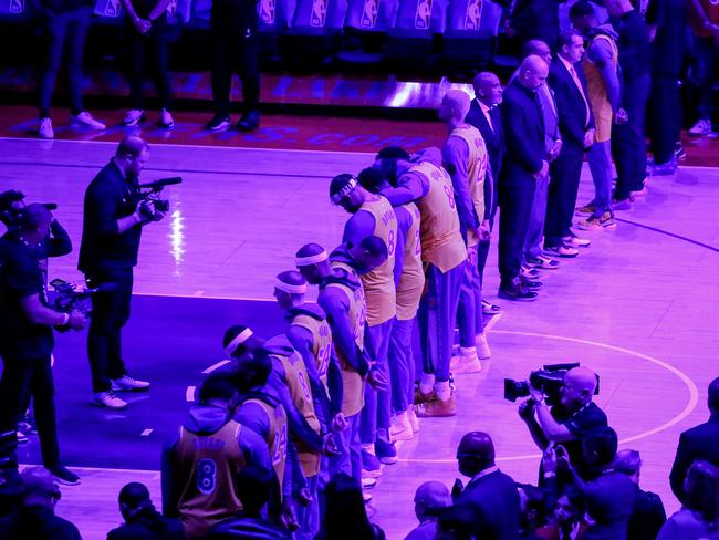 Los Angeles Lakers players stand during a moment of silence for late NBA player Kobe Bryant. Picture: AP Photo/Ringo H.W. Chiu