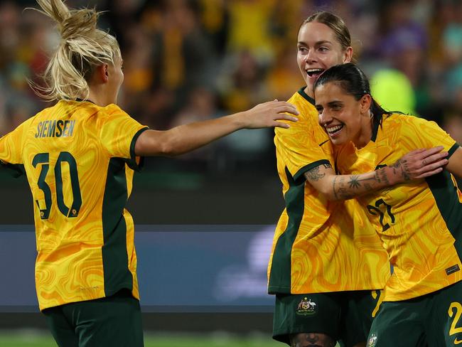 GEELONG, AUSTRALIA - DECEMBER 07: Sharn Freier of Australia celebrates scoring a goal with Alex Chidiac and Remy Siemsen of Australia during the International Friendly Match between the Australia Matildas and Chinese Taipei at GMHBA Stadium on December 07, 2024 in Geelong, Australia. (Photo by Morgan Hancock/Getty Images)