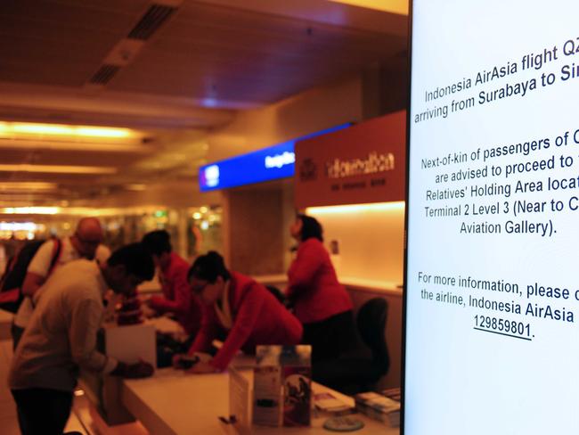 An electronic sign board shows information for AirAsia flight QZ8501 bound for Singapore International Airport on December 28, 2014. Panicked family members have arrived at Surabaya Airport seeking information.