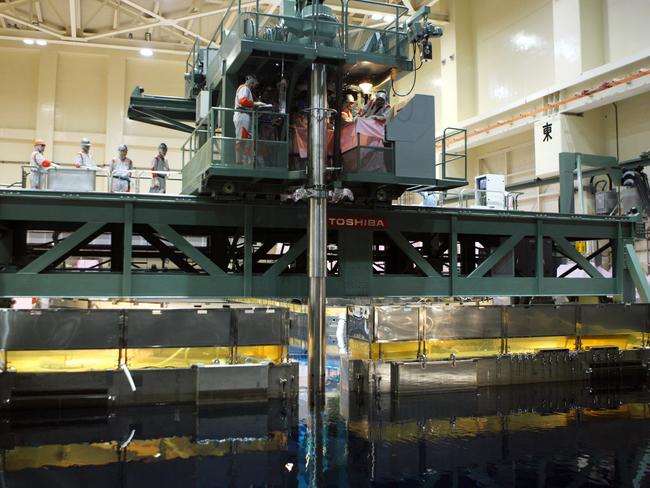 The International Atomic Energy Agency checks a rod containing reprocessed fuel being loaded into a reactor. Picture: Tomohiro Ohsumi/Bloomberg via Getty Images