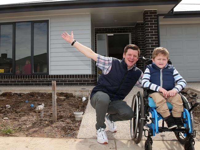 Single dad Aaron McArthur and his son, Abel, have moved into a specially built home to suit his disability. Picture: Alison Wynd