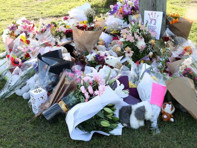 Flowers at the scene of the car fire in Camp Hill. Picture: Liam Kidston