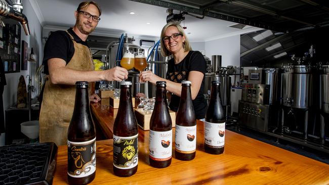 Pictured here is Jimmy Van Eetvelde and Annelies Nijskens of Madocke Beers, with some of the 14 Belgian-style craft beers made from the comfort of their residential garage in Pacific Pines. Picture: Jerad Williams