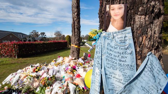 Bouquets of flowers and messages expressing love and loss have been placed at the crash site.