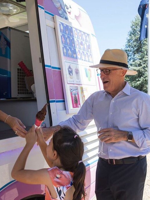 Turnbull looks on as an MP’s daughter is served an ice-cream cone during his summer party at the Lodge. 