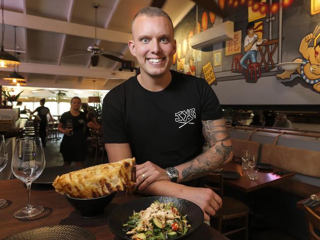 Matt Sinclair at his restaurant Sum Yung Guys at Sunshine Beach, holding the spicy chicken larb and roti. Pic Mark Cranitch.