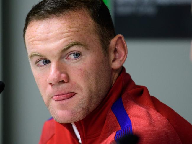 England's striker Wayne Rooney (L) gives a press conference on the eve of the World Cup 2018 football qualification match between Slovenia and England in Ljubljana, on October 10, 2016. / AFP PHOTO / Jure MAKOVEC