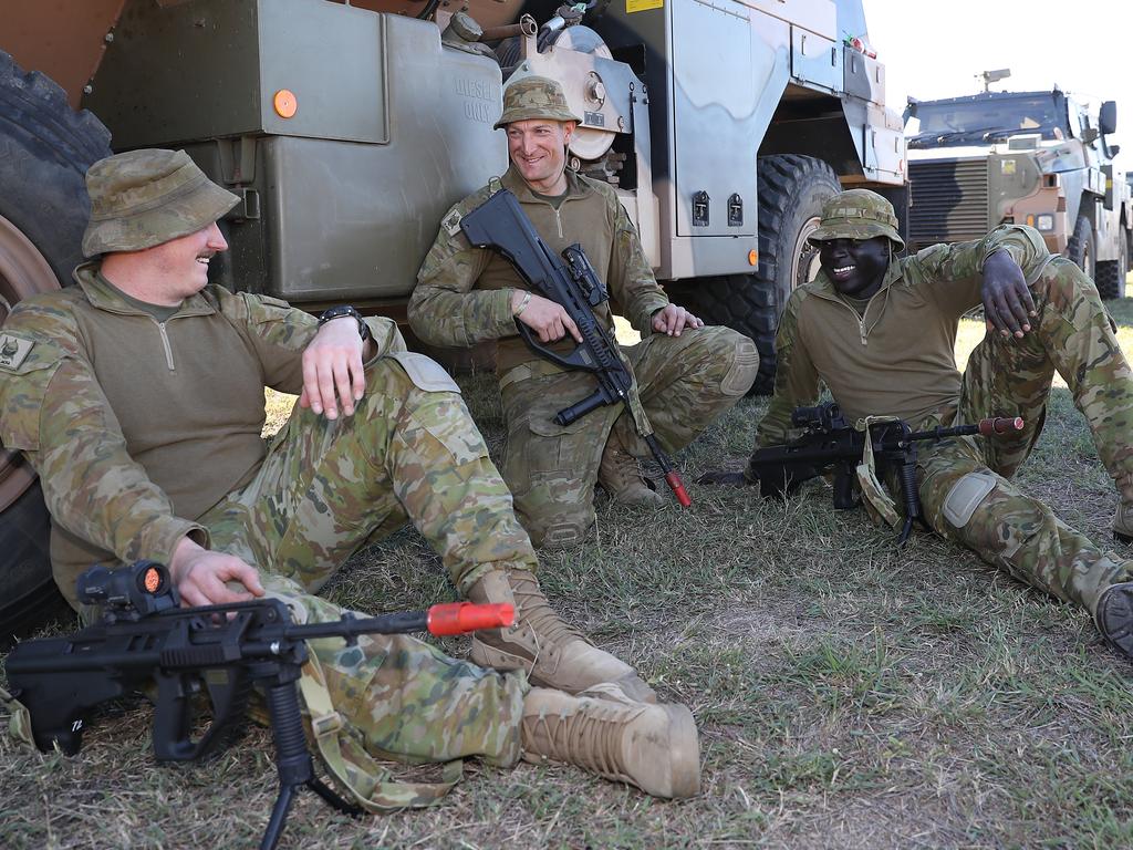 Troopers Ashley Humphries, Darryl Sawley and Kon Thon on the ground at Camp Rocky for the Talisman Sabre training exercise. Picture: Peter Wallis