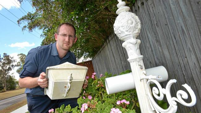 Scott Kovacevic holding a damaged letter box in Gympie. Picture: Renee Albrecht