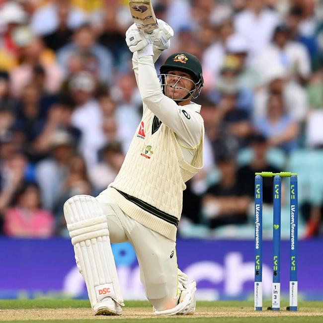 David Warner goes long down the ground. (Photo by Gareth Copley/Getty Images)