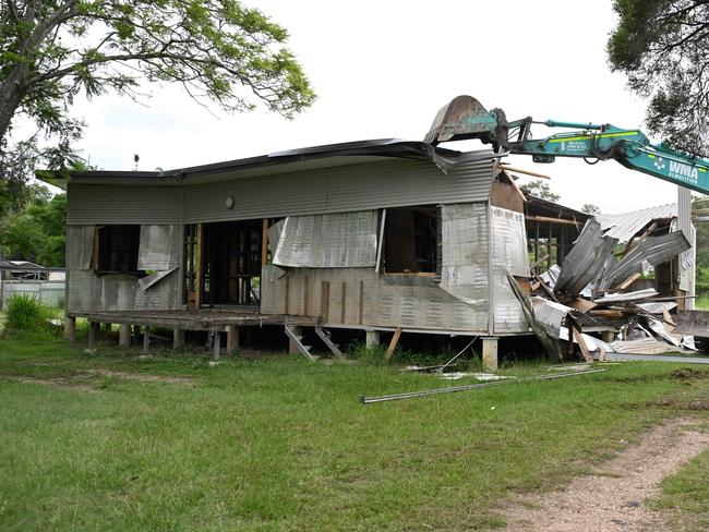 24/01/2023:  Deputy Premier Steven Miles (white shirt), Ipswich mayor Teresa Harding (in pink), member for Oxley, Milton Dick (dark blue) and others as heavy machinery and specialist crews begin demolishing houses in Enid st Goodna, that were among the first bought through the joint Commonwealth and State government $741 million Resilient Homes Fund. pic Lyndon Mechielsen/Courier Mail