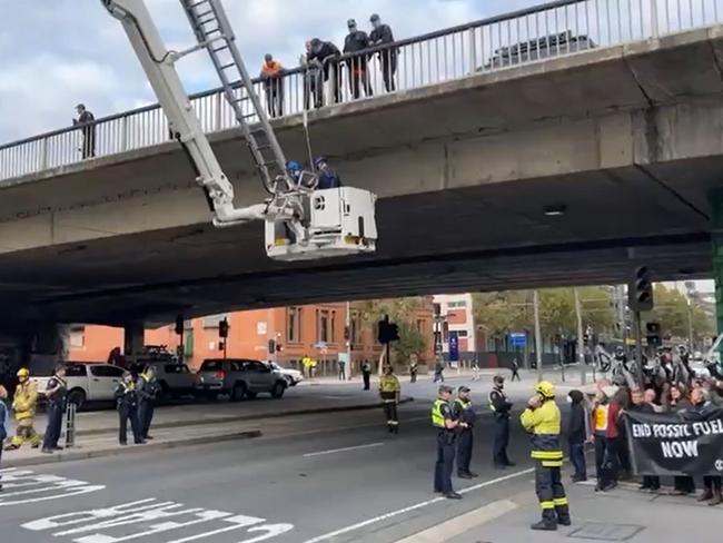 Extinction Rebellion protesters near the Morphett Street Bridge, where one hung suspended, delaying traffic. Picture: Facebook