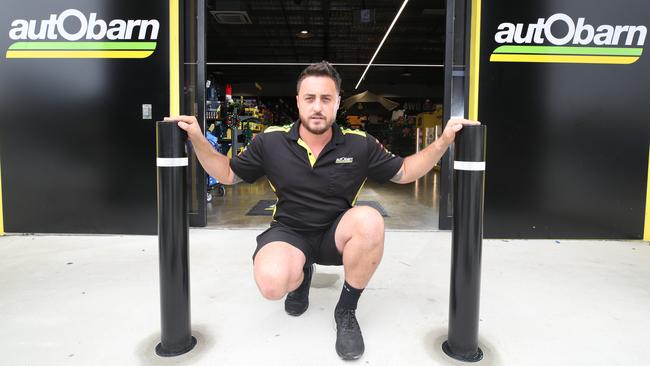 Autobarn Upper Coomera owner Ryan Belovari with new bollards he has had installed after the business was ram-raided twice in five days. Picture: Glenn Hampson.