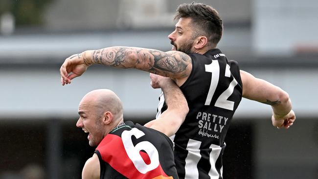 Riddell’s Josh Grabham and Chris Stewart of Wallan compete in the ruck. Picture: Andy Brownbill