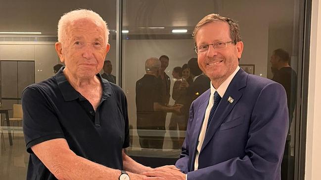 Dov Golebowicz, 92, formerly of Melbourne, who survived the holocaust and last week’s slaughter at nirim kibbutz is embraced by President of Israel Isaac Herzog, in Tel Aviv.