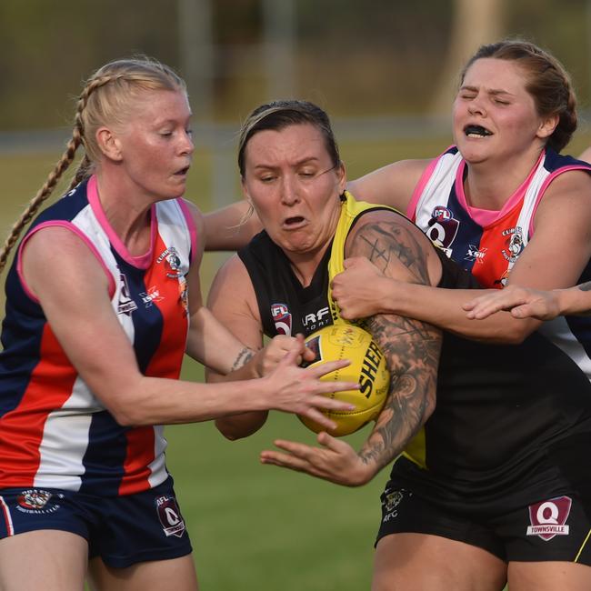 Montana Dove and Mikayla Abson tackle Hayley Cornish of the Tigers. Picture: Evan Morgan