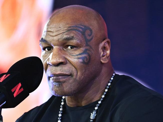 NEW YORK, NEW YORK - AUGUST 18: Mike Tyson (L) and Jake Paul face off at an exclusive press conference ahead of their November bout during the Fanatics Fest NYC 2024 at Jacob Javits Center on August 18, 2024 in New York City.  (Photo by Roy Rochlin/Getty Images for Fanatics)