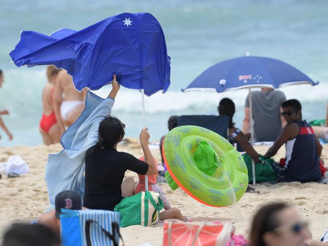 An umbrella is nearly blown over due to strong winds at Bronte Beach earlier this month. Picture: Tracey Nearmy