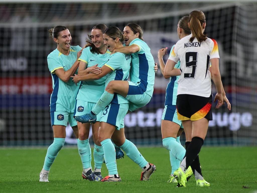 DUISBURG, GERMANY - OCTOBER 28: Kyra Cooney-Cross of Australia celebrates scoring her team's first goal with teammates  during the Women's international friendly match between Germany and Australia at Schauinsland-Reisen-Arena on October 28, 2024 in Duisburg, Germany. (Photo by Alex Grimm/Getty Images)