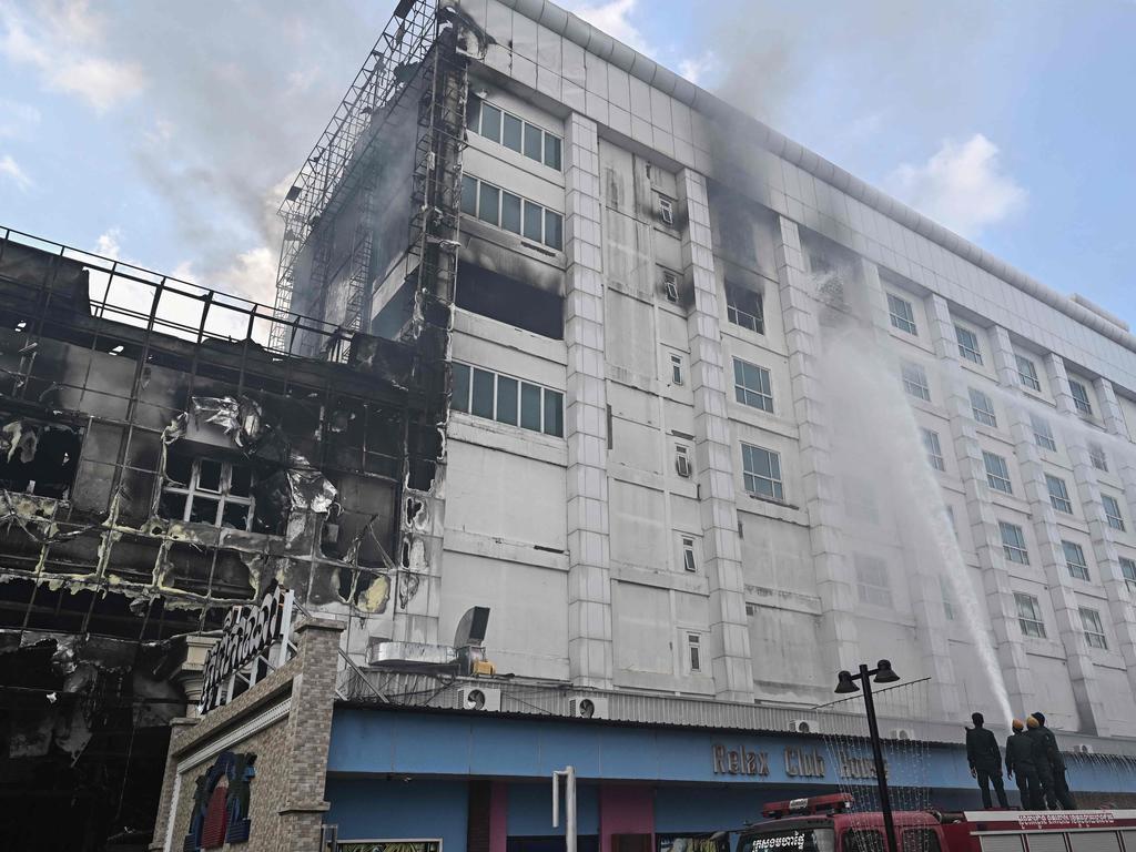 Firefighters spray water onto a fire burning at the Grand Diamond City hotel-casino. Picture: AFP