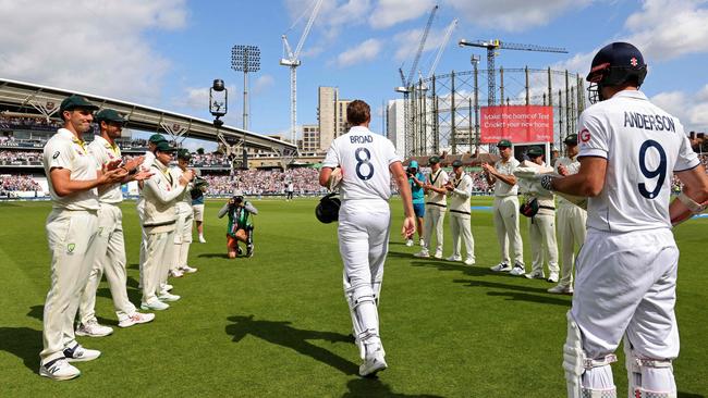 England's Stuart Broad is given a guard of honour by the Australians. (Photo by Adrian DENNIS / AFP)