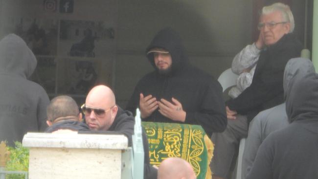 Infamous rapper Ali “Ay Huncho” Younes prays over the coffin of his good mate Murat Gulasi, who was laid to rest on Thursday.