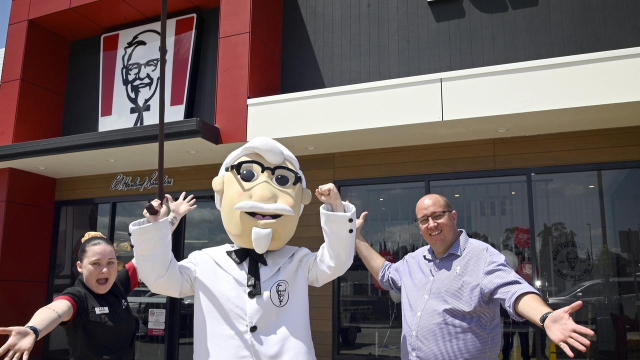 KFC opens in Highfields. KFC mascot, Colonel Sanders, with store manager Amber Harding-Dolan and area manager Trent Brigginshaw.